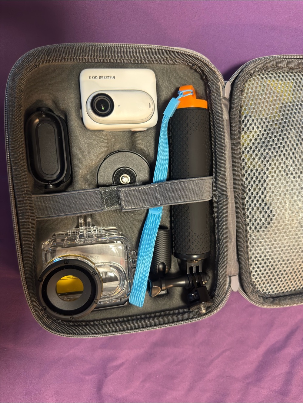 Action Camera Accessory Kit with White Camera and Black/Orange Floating Grip